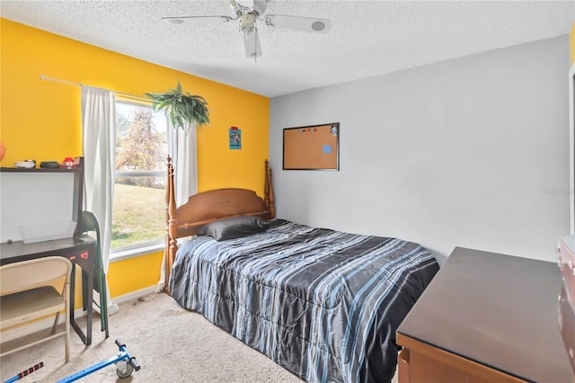 carpeted bedroom featuring ceiling fan and a textured ceiling