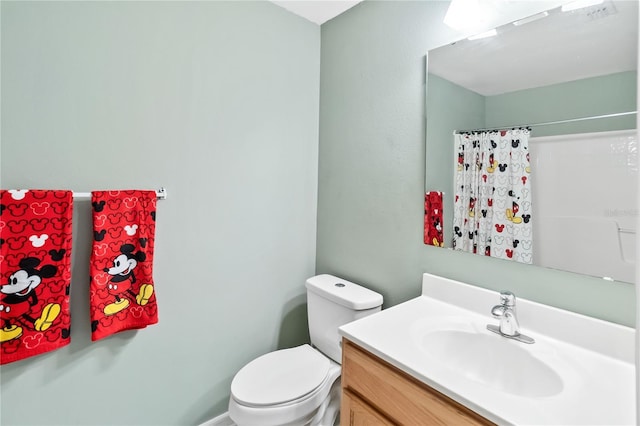 bathroom with vanity, toilet, and a shower with shower curtain