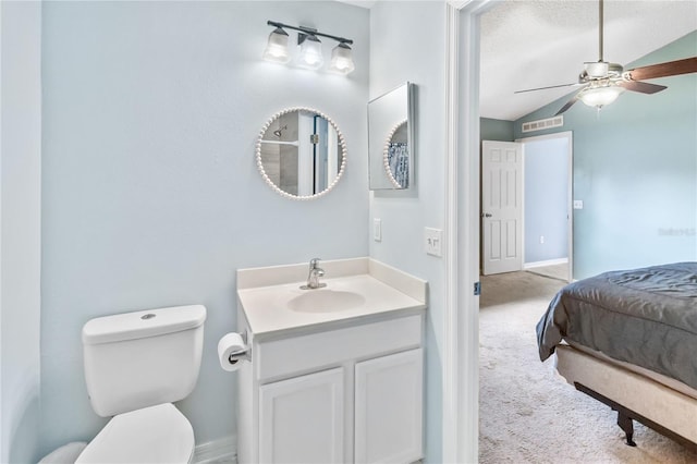 bathroom featuring vanity, ceiling fan, vaulted ceiling, and toilet