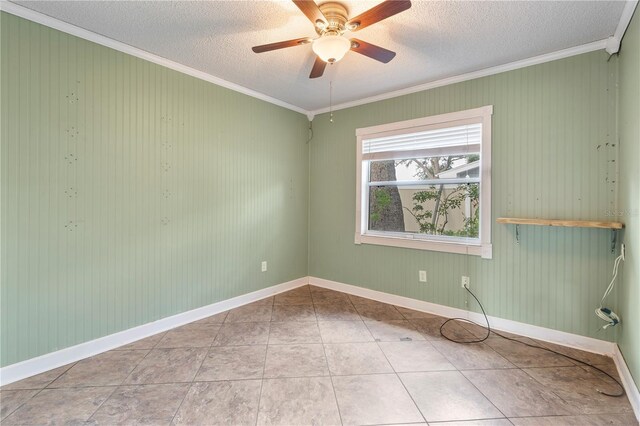 tiled spare room with ceiling fan, ornamental molding, and a textured ceiling