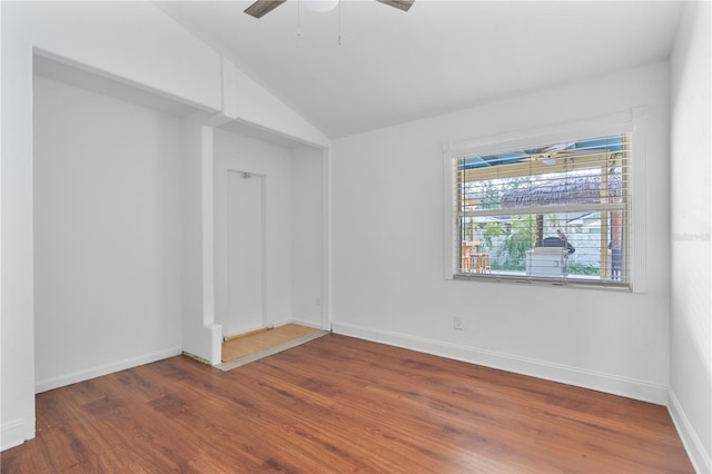 unfurnished room with vaulted ceiling, ceiling fan, and dark hardwood / wood-style flooring