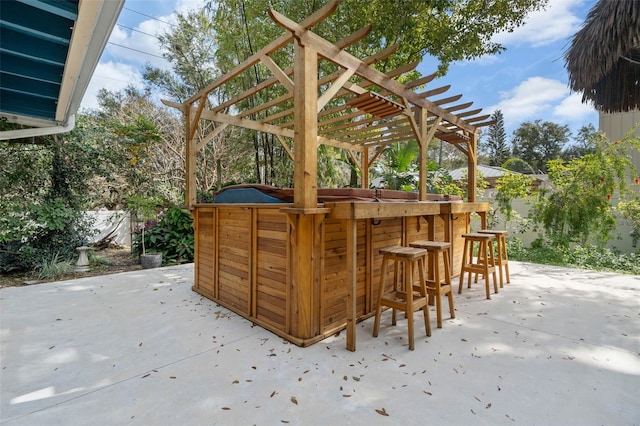 view of patio / terrace featuring a pergola and a bar