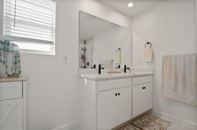 bathroom with vanity and a shower with shower door