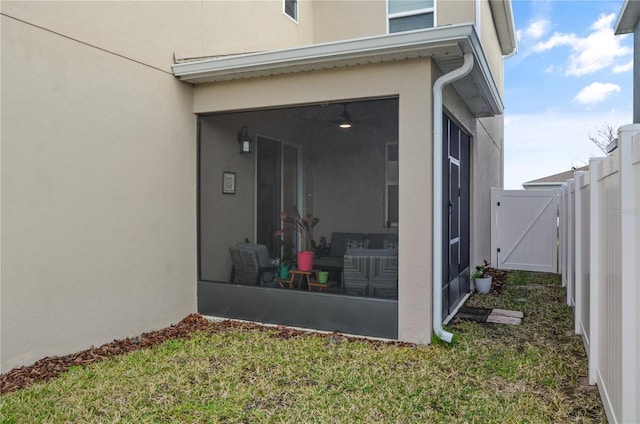 view of exterior entry with a lawn