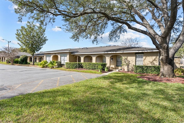 ranch-style house with a front lawn