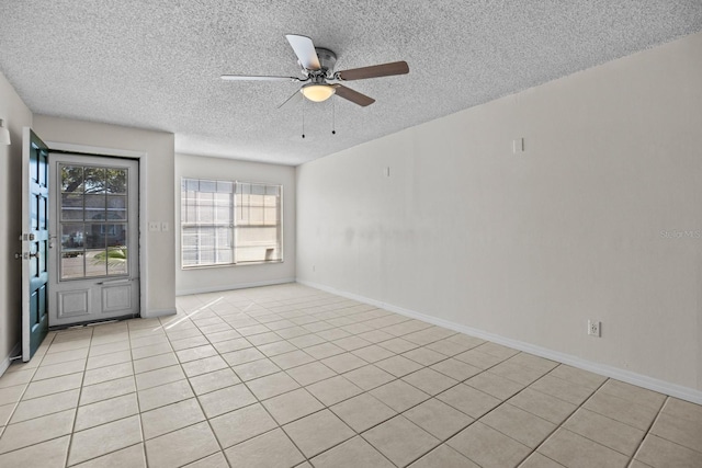 unfurnished room featuring light tile patterned floors, a textured ceiling, and ceiling fan