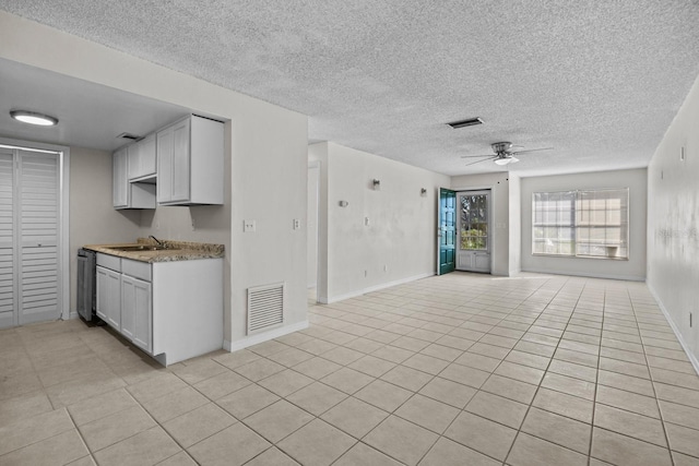 kitchen featuring white cabinetry, ceiling fan, black dishwasher, and sink