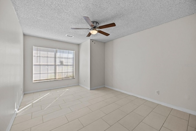 spare room featuring a textured ceiling and ceiling fan