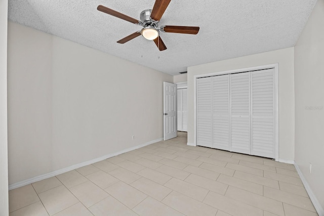 unfurnished bedroom with ceiling fan, a closet, and a textured ceiling