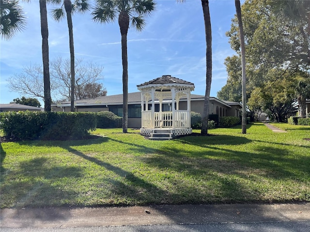 view of front of property with a gazebo and a front yard