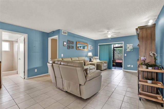 tiled living room with ceiling fan and a textured ceiling