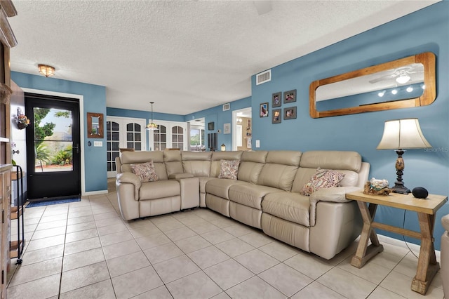 tiled living room with a textured ceiling