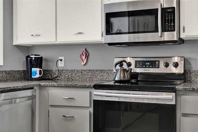 kitchen with appliances with stainless steel finishes and white cabinets