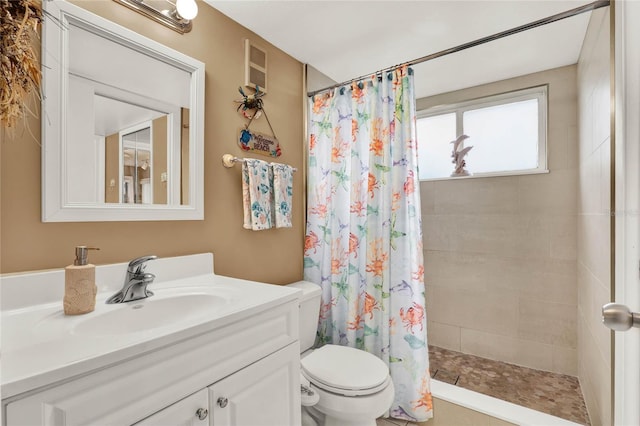 bathroom with vanity, toilet, and walk in shower