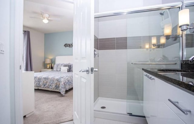 bathroom with walk in shower, ceiling fan, and sink