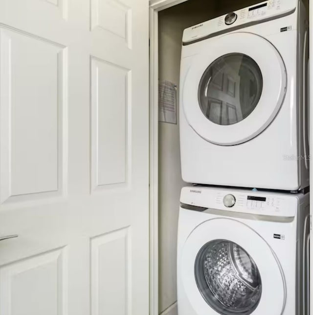 washroom with stacked washer / drying machine