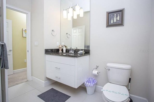 bathroom featuring tile patterned flooring, vanity, and toilet