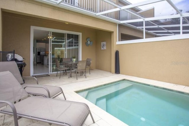 view of pool with a lanai and a patio area