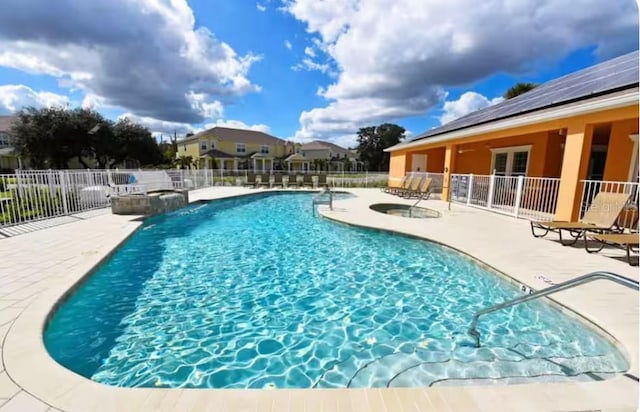 view of swimming pool featuring a patio area and a hot tub