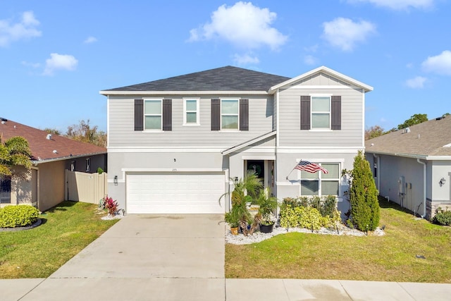 view of front facade with a garage and a front lawn