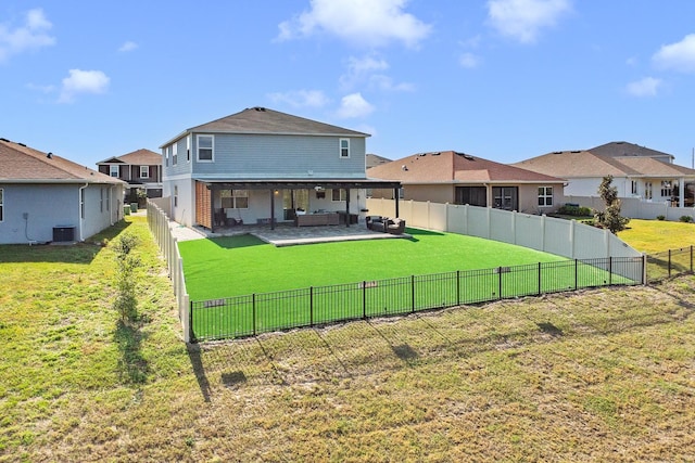 rear view of property featuring cooling unit, an outdoor living space, a patio area, and a lawn