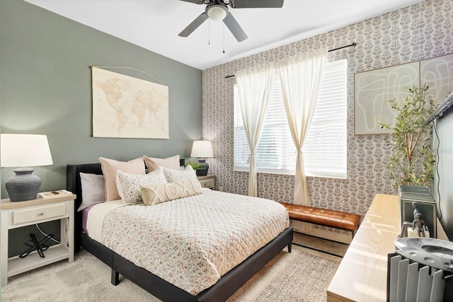 carpeted bedroom featuring a baseboard heating unit and ceiling fan