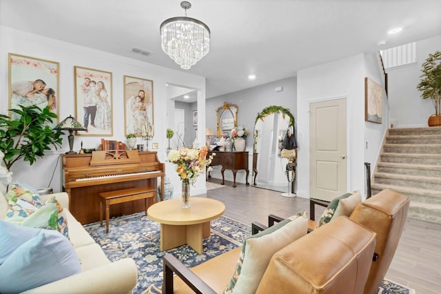 living room featuring a notable chandelier and light hardwood / wood-style flooring