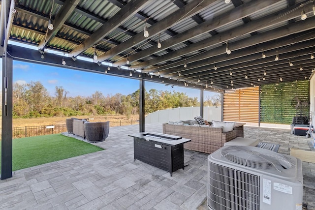 view of patio featuring central AC and an outdoor living space with a fire pit