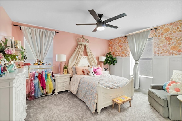 bedroom featuring multiple windows, carpet, and ceiling fan