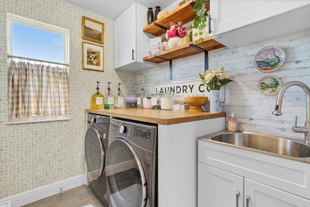 laundry room with cabinets, wet bar, separate washer and dryer, and light hardwood / wood-style floors