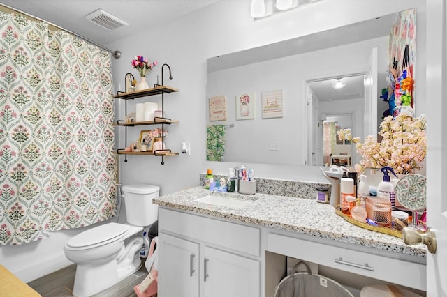 full bathroom with hardwood / wood-style flooring, vanity, toilet, and shower / tub combo