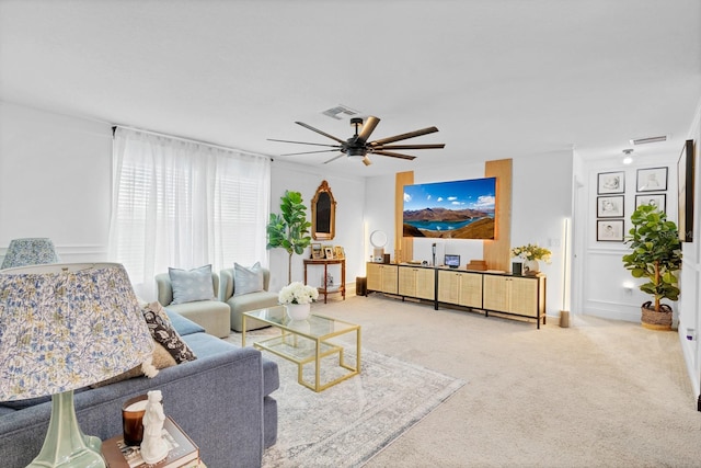 carpeted living room with ceiling fan