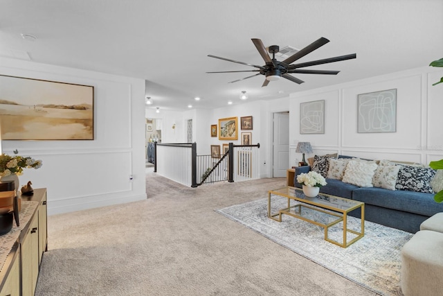 carpeted living room featuring ceiling fan