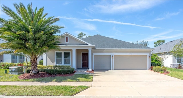 view of front facade featuring stucco siding, concrete driveway, an attached garage, and a shingled roof