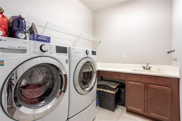 laundry room featuring a sink, light tile patterned flooring, laundry area, and washer and dryer