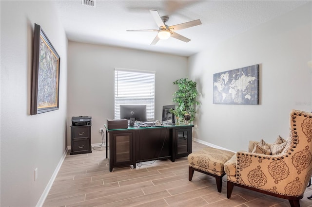 office with baseboards, wood tiled floor, and a ceiling fan