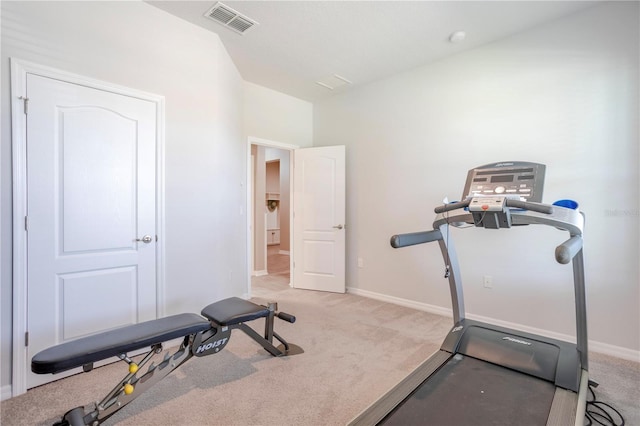 exercise area with visible vents, light colored carpet, and baseboards