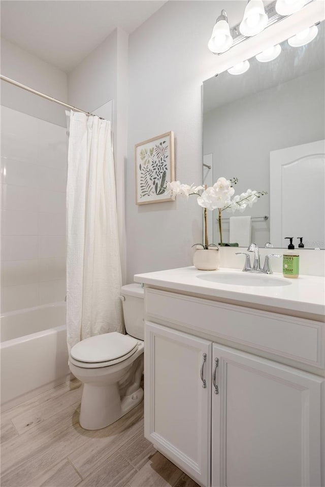 bathroom featuring shower / bath combo with shower curtain, toilet, wood finished floors, and vanity