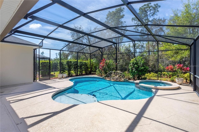 view of pool with a lanai, a patio area, and a pool with connected hot tub