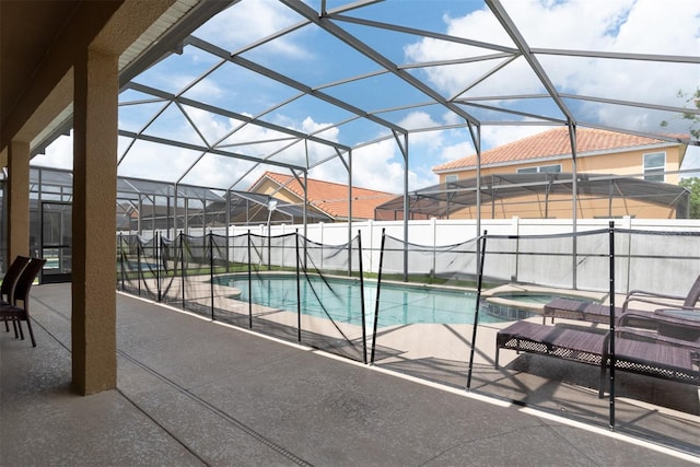 view of pool featuring an in ground hot tub, a lanai, and a patio