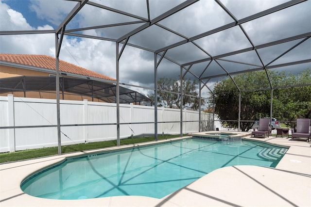 view of swimming pool with an in ground hot tub, a lanai, and a patio area
