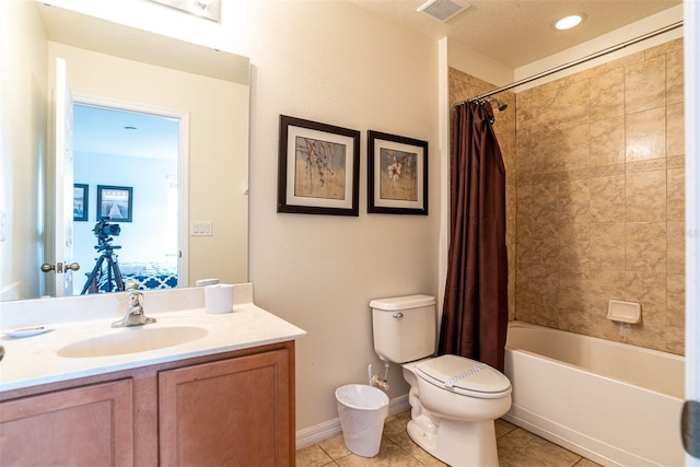 full bathroom with shower / tub combo with curtain, tile patterned floors, toilet, a textured ceiling, and vanity