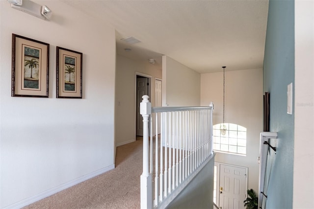 corridor with light colored carpet