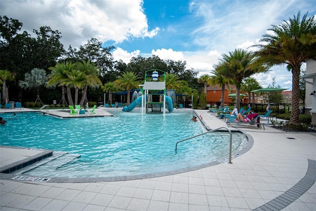 view of swimming pool featuring a playground