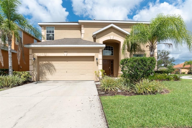 view of front of home featuring a garage and a front yard