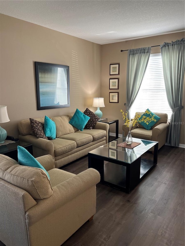 living room featuring a textured ceiling and dark hardwood / wood-style flooring