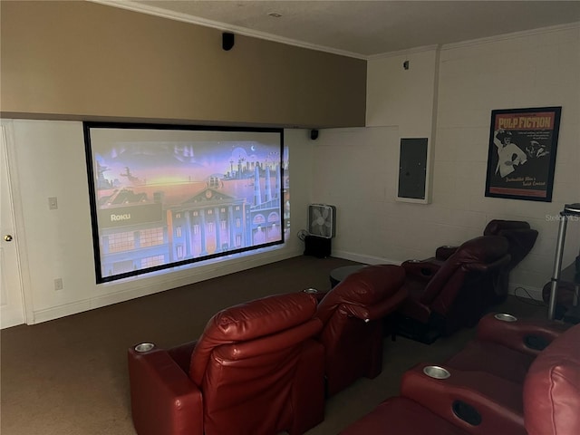 home theater with ornamental molding, electric panel, and dark colored carpet