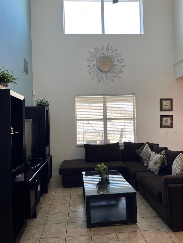 tiled living room with a high ceiling
