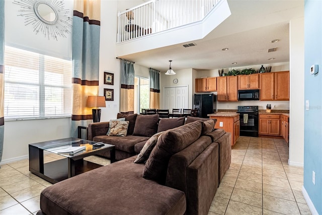 tiled living room with a high ceiling