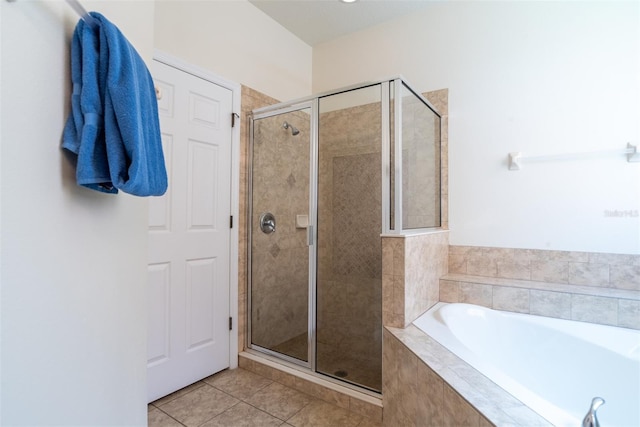 bathroom featuring tile patterned flooring and shower with separate bathtub